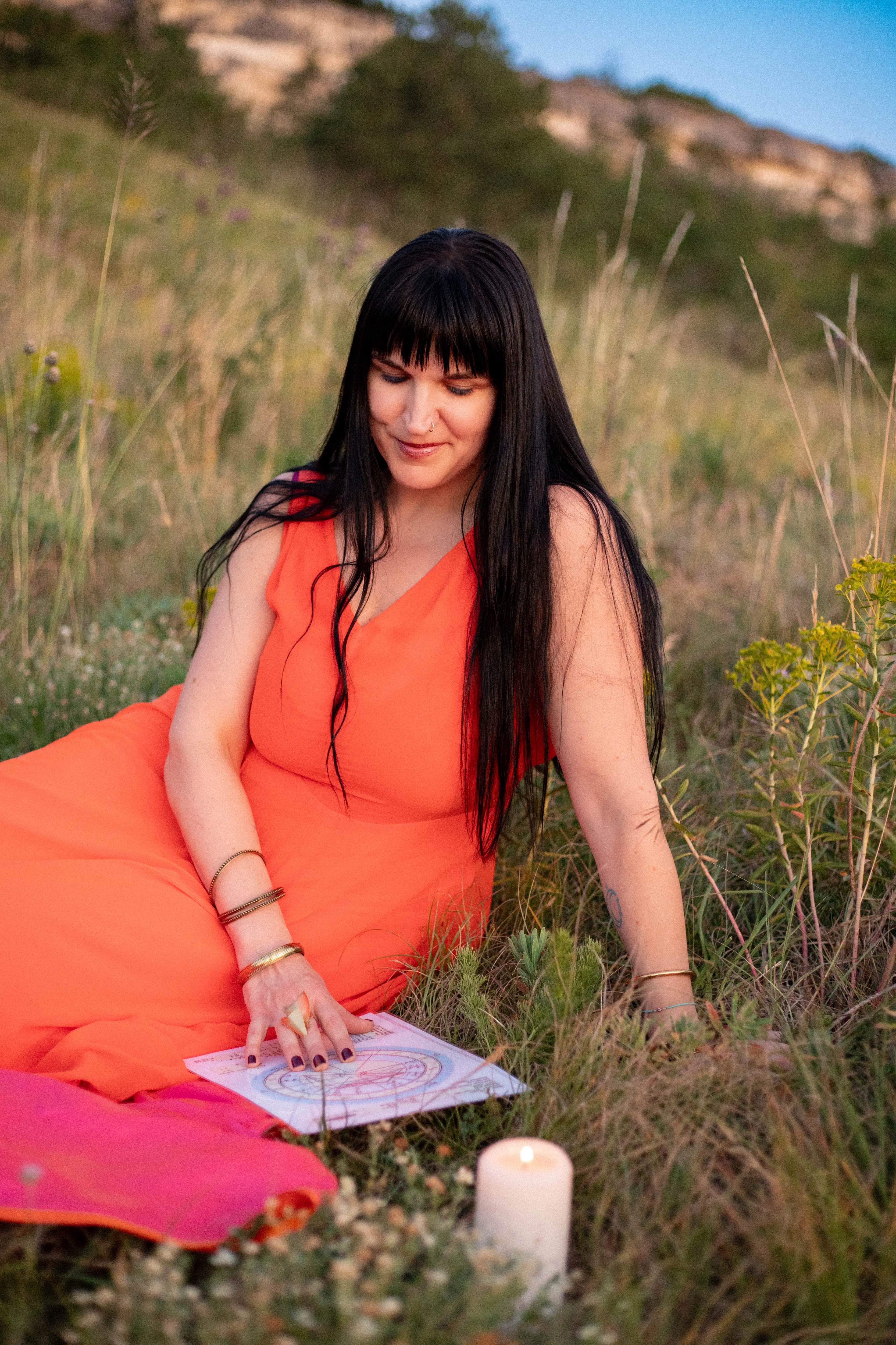 Adrienne with her hand resting over her heart, eyes closed, golden hour light